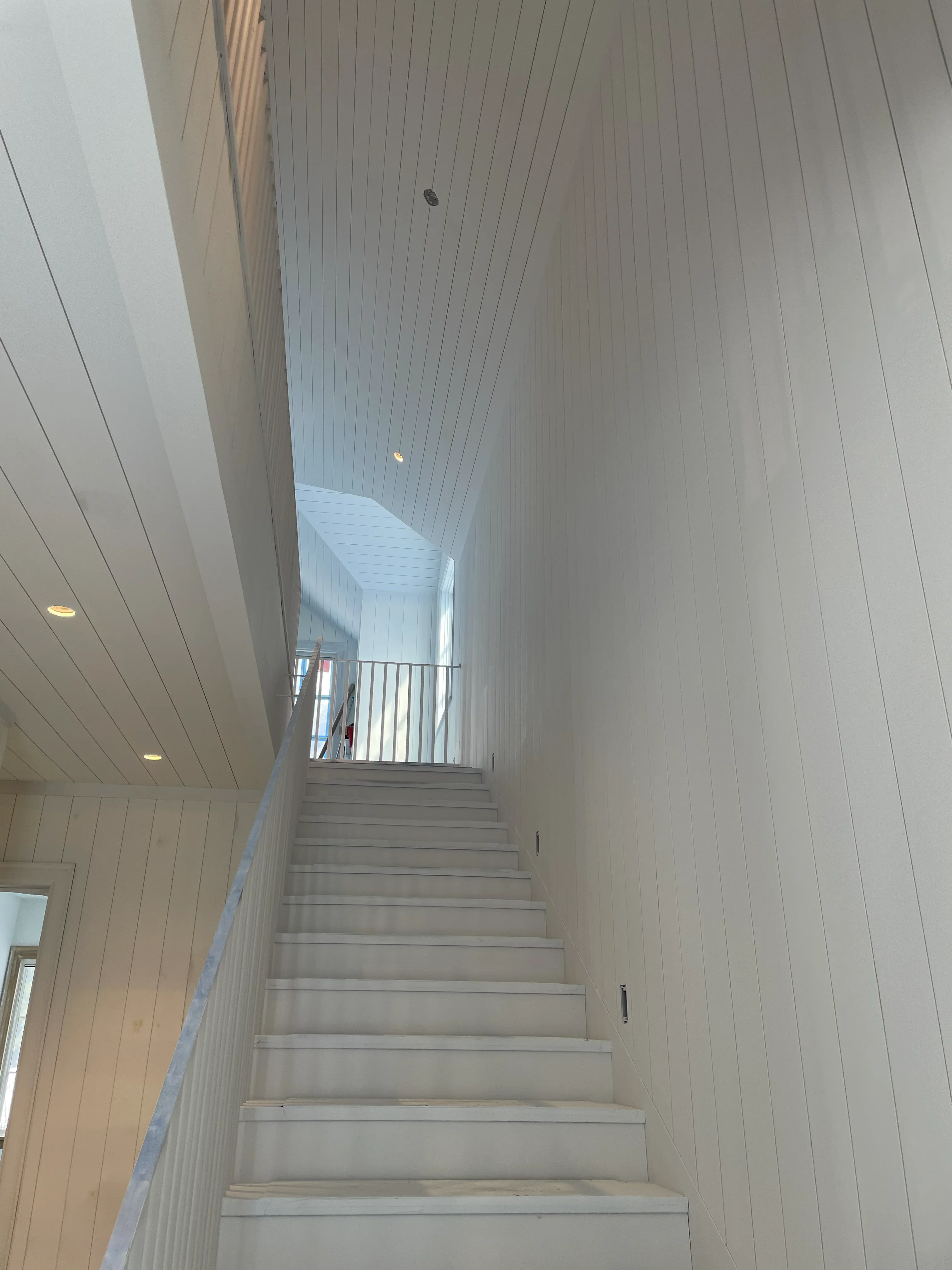 Shiplap stairwell and loft under construction by Gerhard and Sons