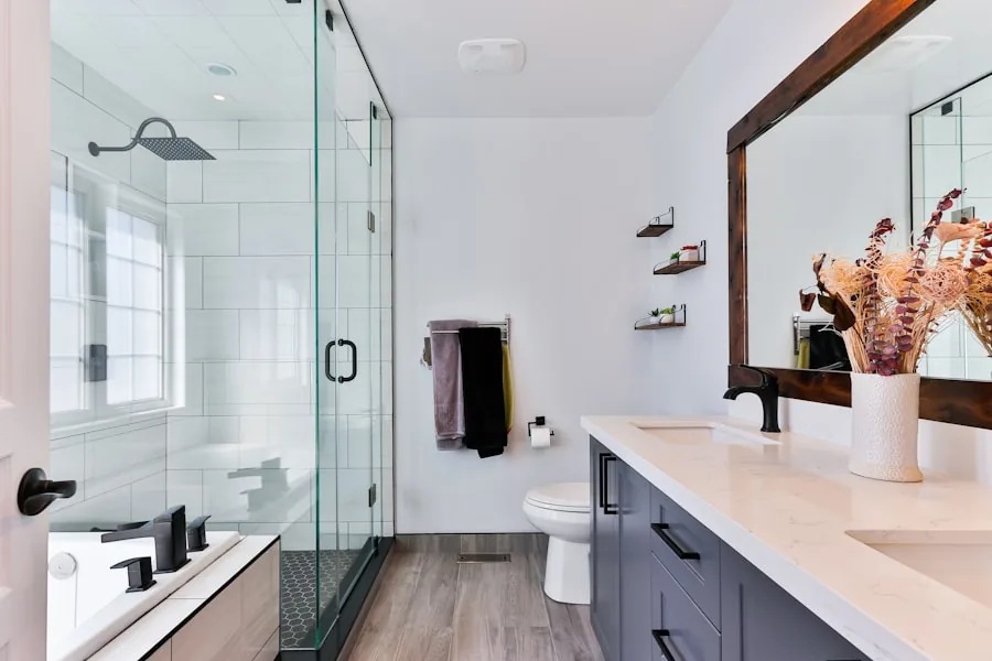 Modern bathroom remodel with glass walk-in shower, blue vanity, and wood-framed mirror by Gerhard and Sons